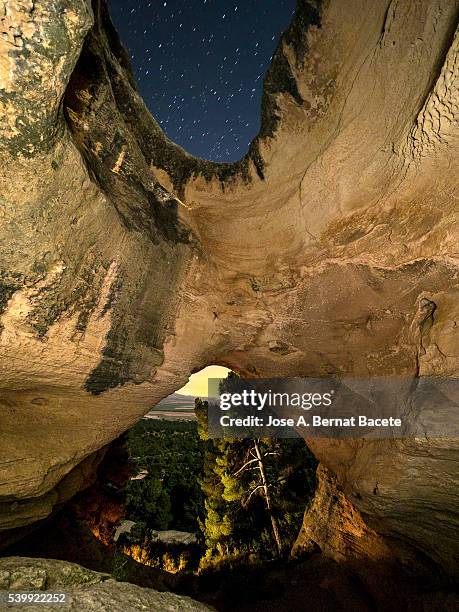 interior during the night  of the cave,  cueva horadada, " the perforated one " placed in the mount arabí. heritage of the humanity. unesco - pinnacle rock formation fotografías e imágenes de stock