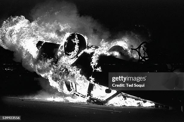 Car is overturn and set ablaze near the LAPD headquarters, in downtown Los Angeles. Los Angeles has undergone several days of rioting due to the...