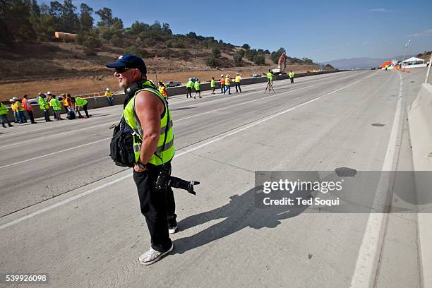 Local media rush on to the 405 freeway to do newscast and photographs. Carmageddon 2 in Los Angeles. Construction crews demolish the Mulholland...