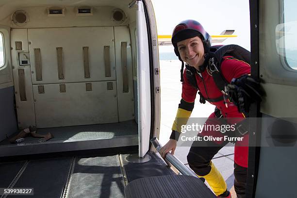 skydiver girl is entering the plane at dubai city - fallschirmsprung stock-fotos und bilder