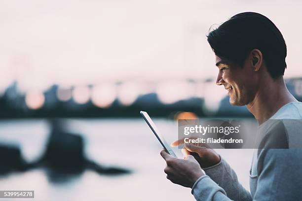 young japanese man texting on the tablet - male teen tablet bildbanksfoton och bilder