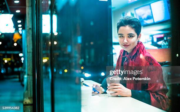 pretty 19-years-old girl using smartphone in cafe - 18 19 years stock pictures, royalty-free photos & images