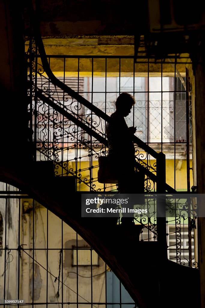 Silhouette of woman on stairs in Havana C