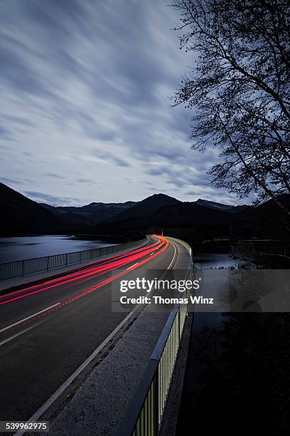 light streaks on a bridge - tail light stock pictures, royalty-free photos & images