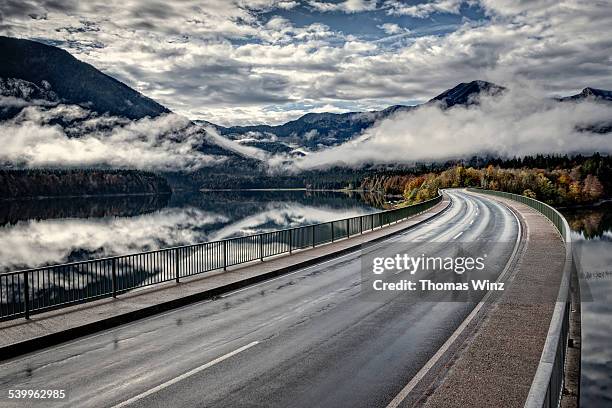 bridge over a lake - entsättigt stock-fotos und bilder