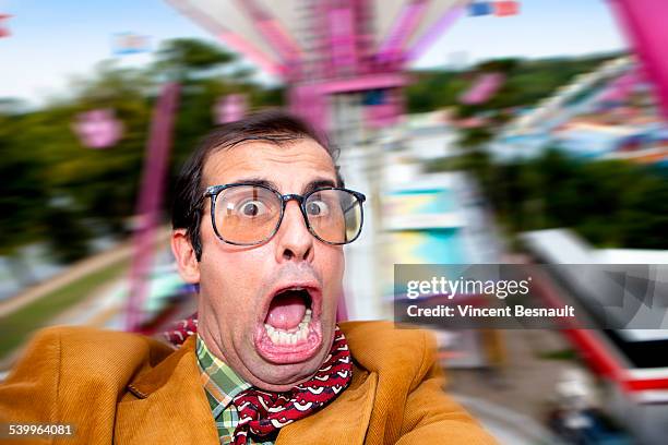 happy man doing a selfie at carousel - kirmes fahrgeschäft stock-fotos und bilder