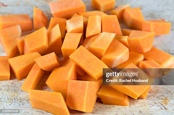 chopped butternut squash on chopping board - butternut squash cubes stock pictures, royalty-free photos & images