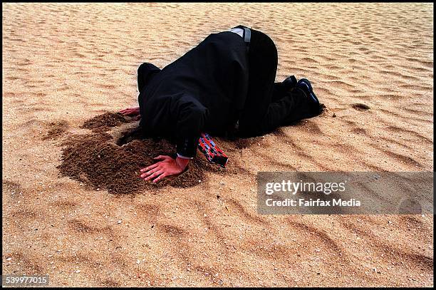 Generic businessman with his head in the sand, 27 February 2002. AFR Picture by GABRIELE CHAROTTE