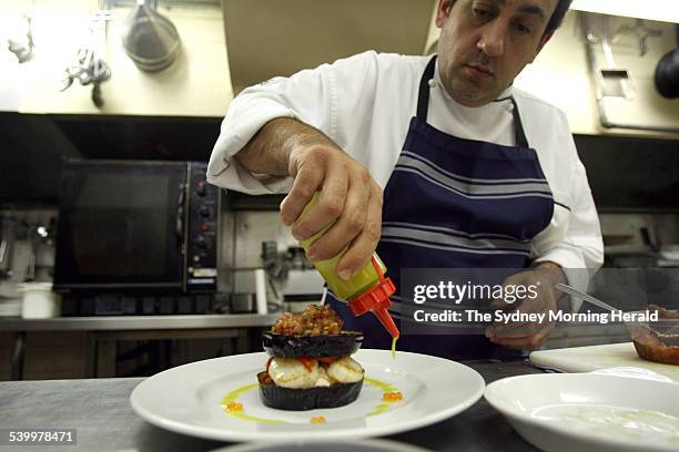 Chef Peter Conistis, from the Omega restaurant, prepares his moussaka, 30 March 2006. SMH Picture by LEE BESFORD