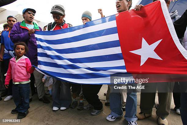 Some of the 42 West Papuan refugee's arriving in Melbourne after being granted temporary protection visa's. Seen here holding their flag which would...