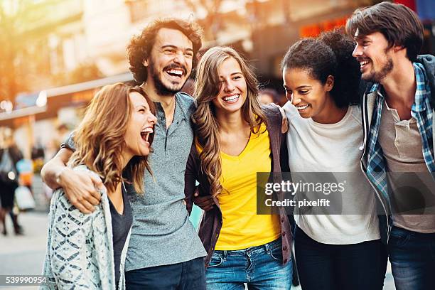 group of friends on the street - walking street friends stock pictures, royalty-free photos & images