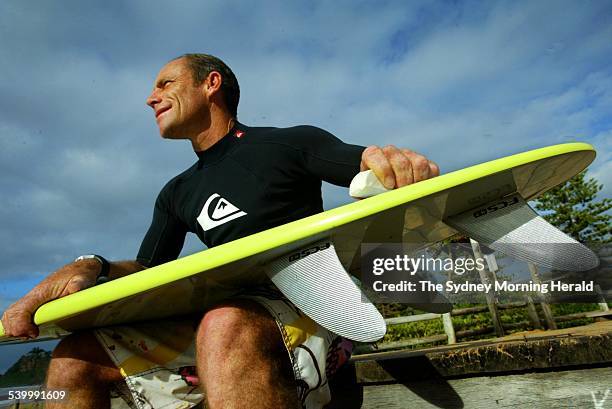 Former two-time World Surfing champion Tom Carroll waxes his board before heading out for a surf at his home beach, Newport, on Sydney's Northern...