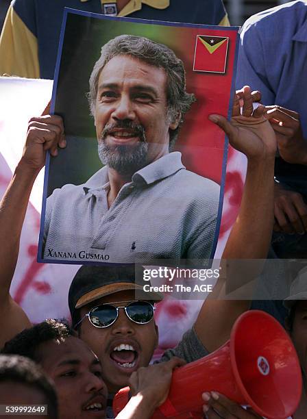 Demonstrator holds up a picture of CNRT leader Xanana Gusmao at a pro-independence student rally at a university in East Timor's capital, Dili, 7 May...