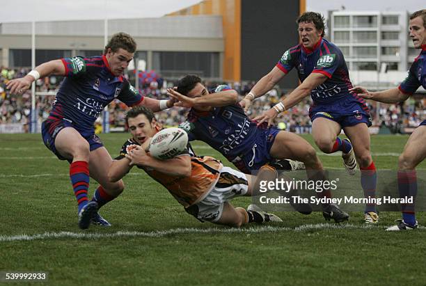 The Tigers' Dean Collis loses the ball in a tackle over the line in the final few minutes of the Round 10 NRL rugby league match between the...