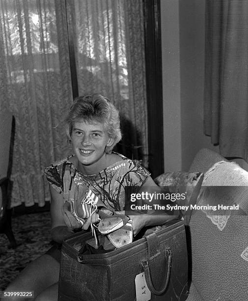 Australian athlete, Betty Cuthbert, at home with her famous running shoes, 13 March 1963. SMH Picture by FRANK BURKE