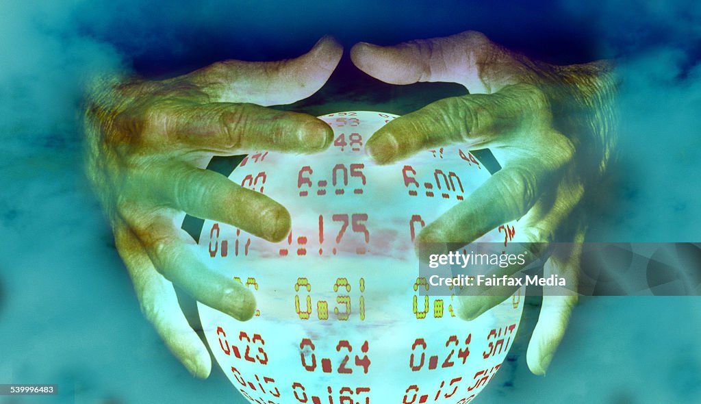 Hands over a crystal ball predicting share prices, 20 November 2000. AFR Photo