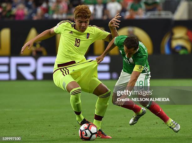 Venezuela's Adalberto Penaranda and Mexico's Andres Guardado vie for the ball during their Copa America Centenario football tournament match in...