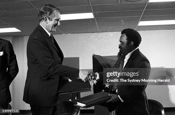 Australian Prime Minister Malcolm Fraser and Papua New Guinea Prime Minister Michael Somare shake hands after signing the Torres Strait Treaty at PNG...