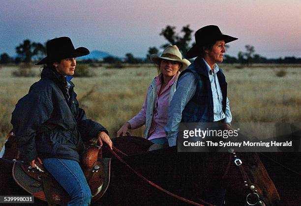 Janelle Little, right and her daughters Tanielle, left and Sharna centre, watch over cattle 40km from Moree on the Gwydir Highway, 7 July 2006. SMH...