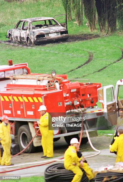 Emergency services personnel work at the site at the Seascape Guesthouse, which was burnt down during the Port Arthur massacre. A burnt out BMW...