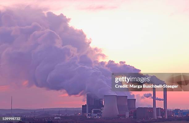 power plant releasing steam - smoke stack stock pictures, royalty-free photos & images