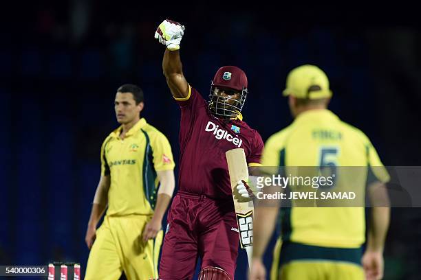West Indies cricketer Kieron Pollard celebrates their victory over Australia during their One Day International match of the Tri-nation Series at the...