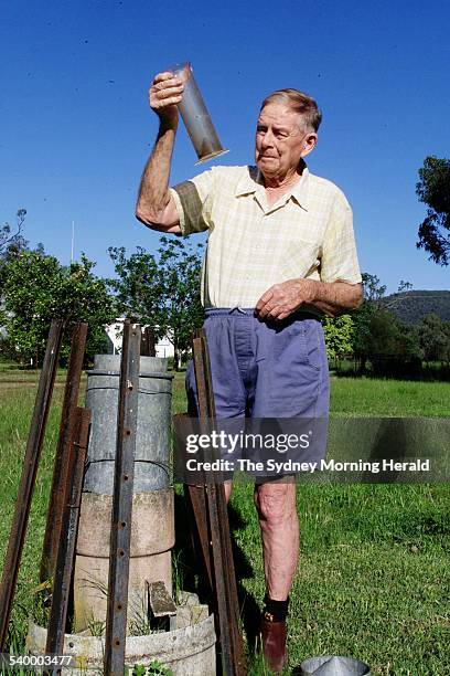 Mr Robert Adams of Carroll, 19km East of Gunnedah, checks the rain gauge on his property, 23 November 2000. SMH Picture by RICK STEVENS