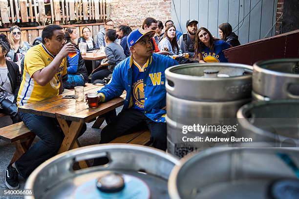 Golden State Warriors fans watch the first quarter of Game 5 of the 2016 NBA Finals between the Warriors and the Cleveland Cavaliers on June 13, 2016...