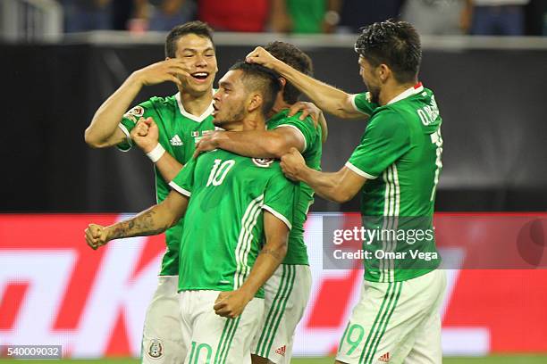 Jesus Manuel Corona of Mexico celebrates with teammates after scoring the first goal of his team during a group C match between Mexico and Venezuela...