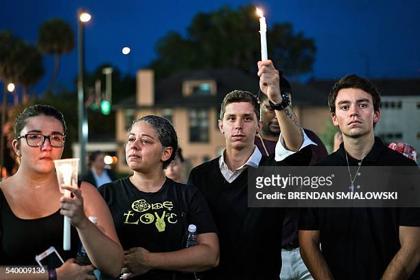 From left Renae Feldt, Patricia Rivera, Journey Cromwell and Thomas Winter attend a vigil outside the Dr. Phillips Center for the Performing Arts for...