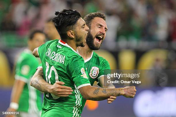 Jesus Manuel Corona of Mexico celebrates with teammate Miguel Layun after scoring the first goal of his team during a group C match between Mexico...