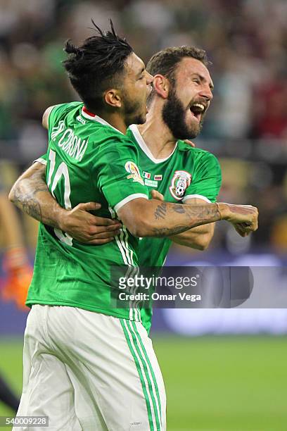 Jesus Manuel Corona of Mexico celebrates with teammate Miguel Layun after scoring the first goal of his team during a group C match between Mexico...