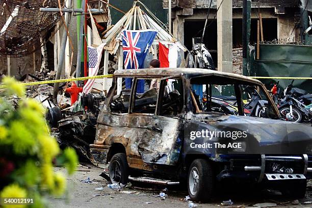 Bali Bombing 2002. An Australian flag hangs amid the ruins of buildings in Kuta, after an explosion ripped through the area, killing dozens of...