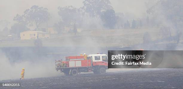 Local firemen fight a bushfire that has broken out in scrub near Gunnedah, NSW.