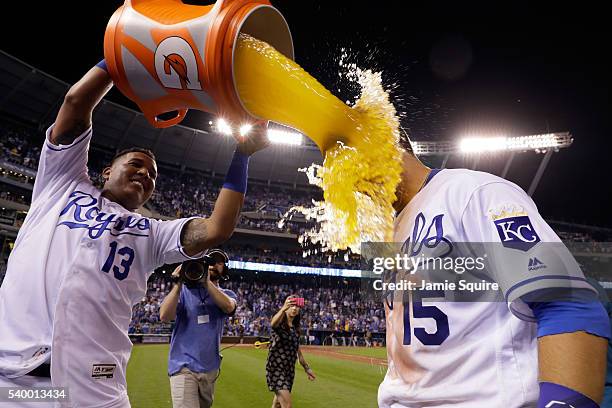 Whit Merrifield of the Kansas City Royals is doused with a bucket of Gatorade by catcher Salvador Perez after the Royals defeated the Cleveland...