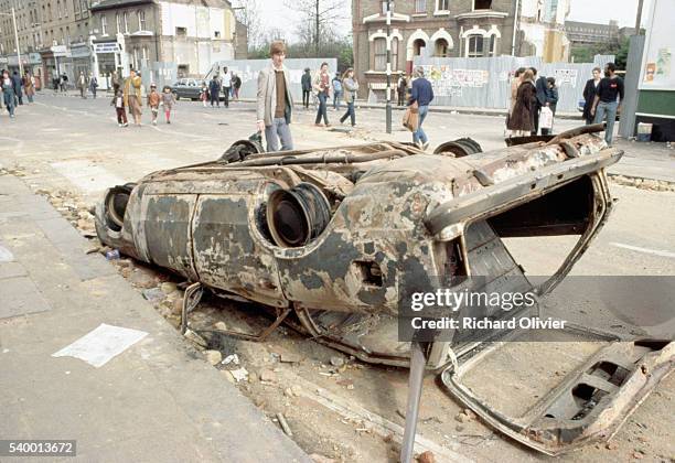 Wrecked buildings and cars in Brixton, London, following the 1981 riots.