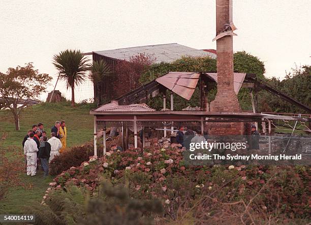 Police investigate in the ruins of the Seascape Guesthouse, where gunman Martin Bryant retreated after shooting and killing 35 people at the Port...