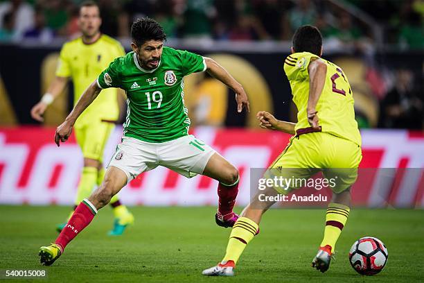 Oribe Peralta of Mexico struggle for the ball against Rolf Feltscher of Venezuela during the 2016 Copa America Centenario Group C match between...