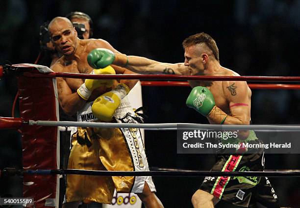 Anthony 'The Man' Mundine and his opponent Danny 'The Machine' Green fight it out during the first round of their long awaited clash at Aussie...