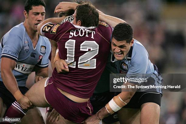 Queensland's Matthew Scott is tackled during game one of the State of Origin rugby league match between NSW and Queensland at Telstra Stadium, 24 May...