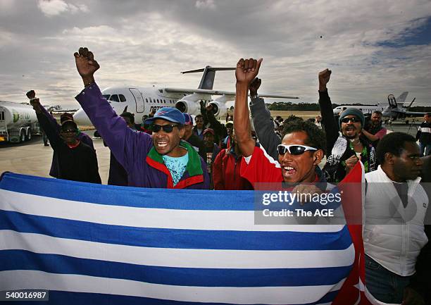 Some of the 42 West Papuan refugee's arriving in Melbourne after being granted temporary protection visa's. Seen here holding their flag which would...