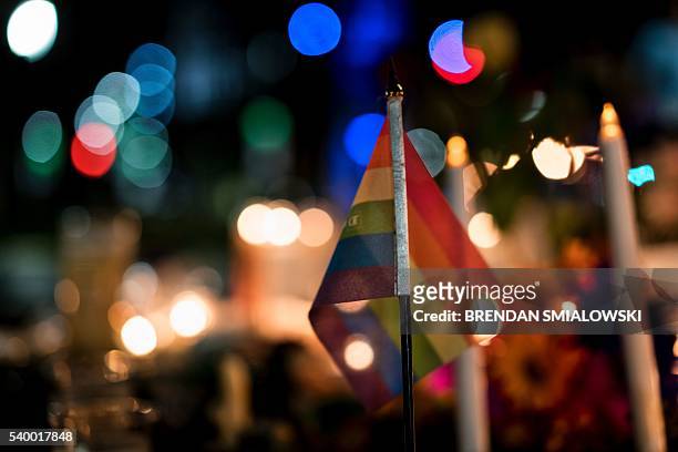 Gay pride flag is seen at a memorial after a vigil outside the Dr. Phillips Center for the Performing Arts for the mass shooting victims at the Pulse...