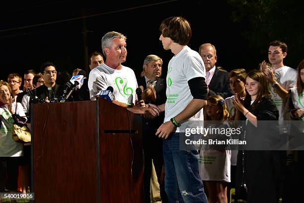 The Mayor of Evesham Township, NJ Randy Brown greets the brother of Christina Grimmie, Mark Grimmie, at the podium during the Vigil For Christina...