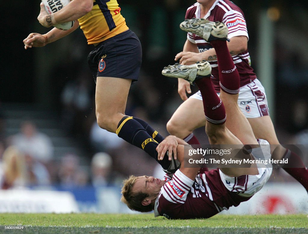 The Eels' Timana Tahu runs over top of Manly's Brett Stewart during the Round 8