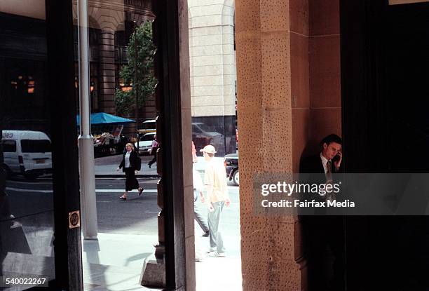 Worker takes a short break during lunch hour, outside the General Post Office building, Martin Place, Sydney, 7 October 1999. AFR Picture by ANGELA...