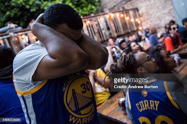 Golden State Warriors fans react in disappointment as the Warriors begin to lose Game 5 of the 2016 NBA finals against the Cleveland Cavaliers on...