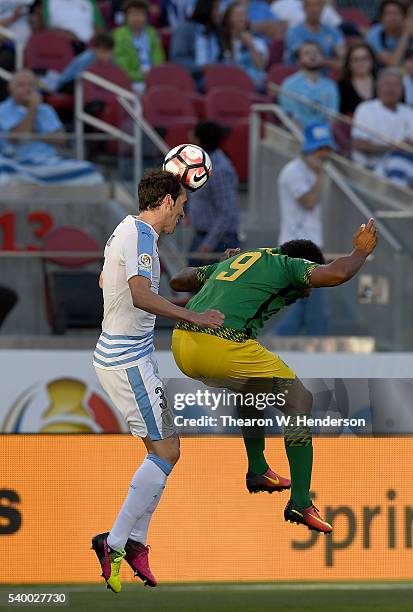 Diego Godin of Uruguay hit a header over the top of Giles Barnes of Jamaica during the 2016 Copa America Centenario Group match play between Uruguay...