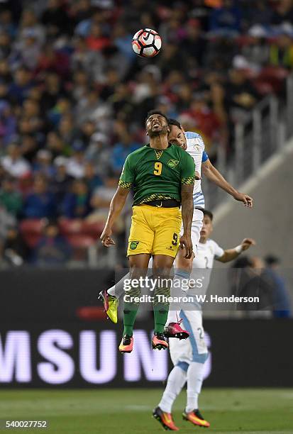 Giles Barnes of Jamaica hits a header away from Diego Godin of Uruguay during the 2016 Copa America Centenario Group match play between Uruguay and...