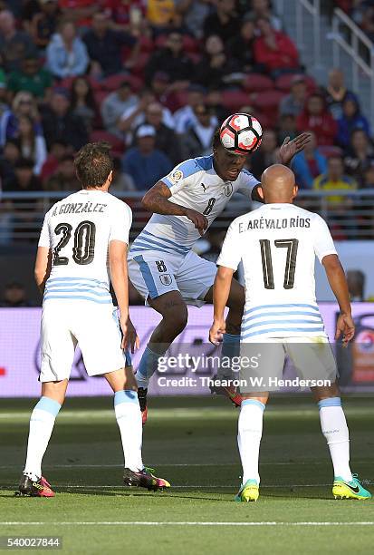 Abel Hernandez of Uruguay hits a header as teammates Alvaro Gonzalez and Egidio Arevalo looks on against Jamaica during the 2016 Copa America...