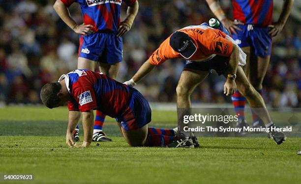 Newcastle Knights Andrew Johns crouches on the field after being injured during a rugby league match against St George Illawarra Dragons, 14...